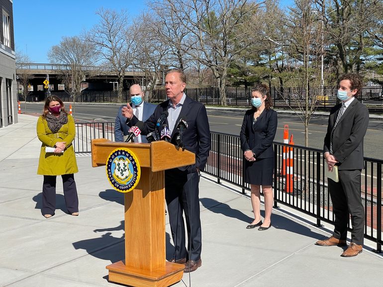 Gov. Ned Lamont outside a transit-oriented development in New Britain to promote the Transportation Climate Initiative. From left, Mayor Erin Stewart, Deputy Commissioner Garrett Eucalitto of DOT, Commissioner Katie Dyke of DEEP and Sen. Will Haskell.