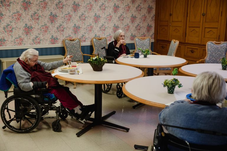 Residents at Beechwood, a nursing home in New London, have lunch together in a dining room while social distancing.